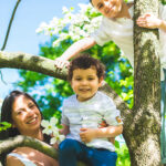 Canva - Family posing on a tree