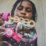 Canva - Girl Blowing Bubbles